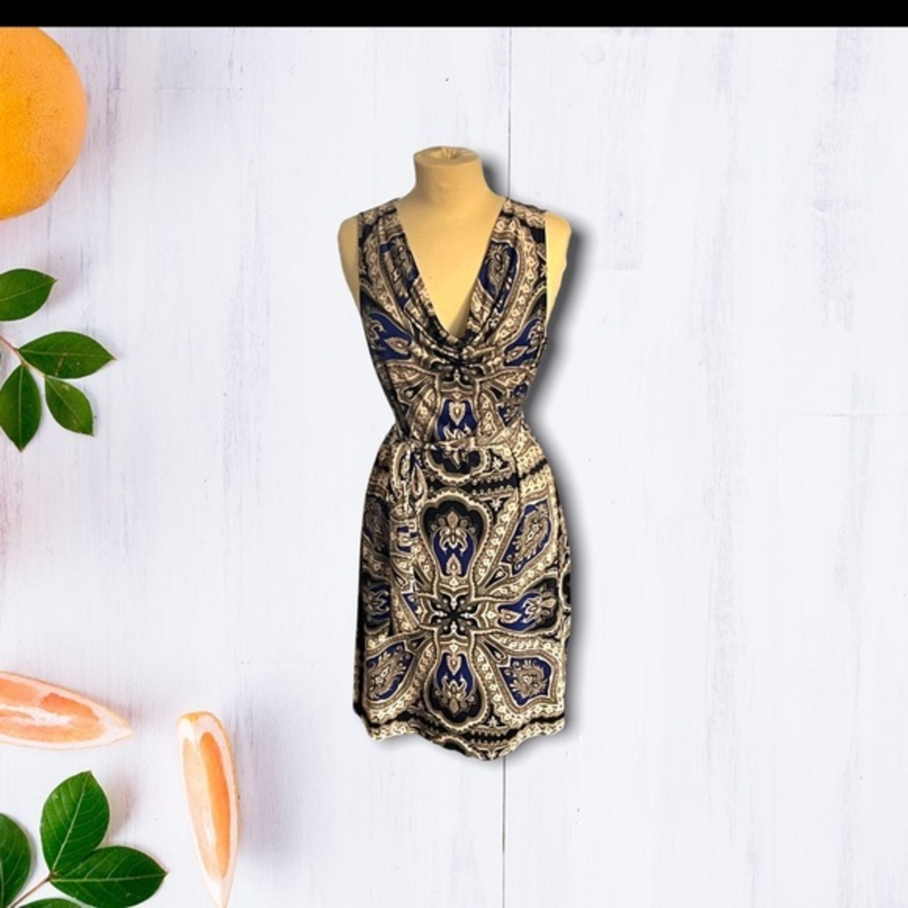 Sleeveless dress with‎ draped neck and tie at waist.